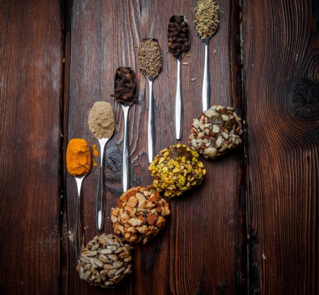 top-view-sweets-handmade-teaspoons-with-spices-handmade-sweets-from-nuts-dried-fruits-honey_176474-2558